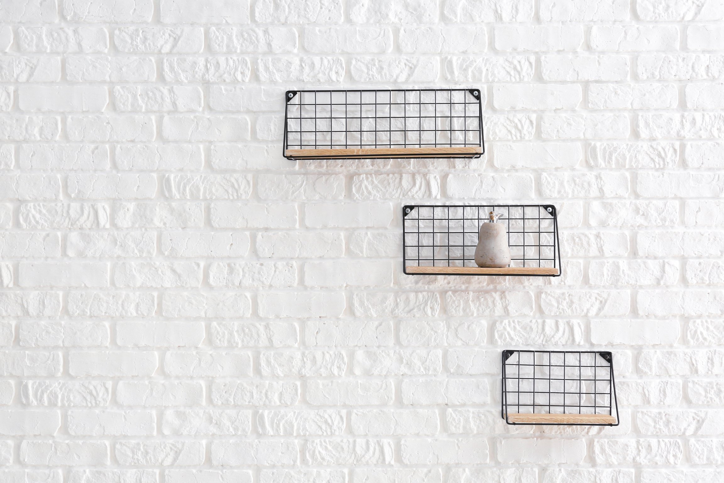 Shelves Hanging on White Brick Wall